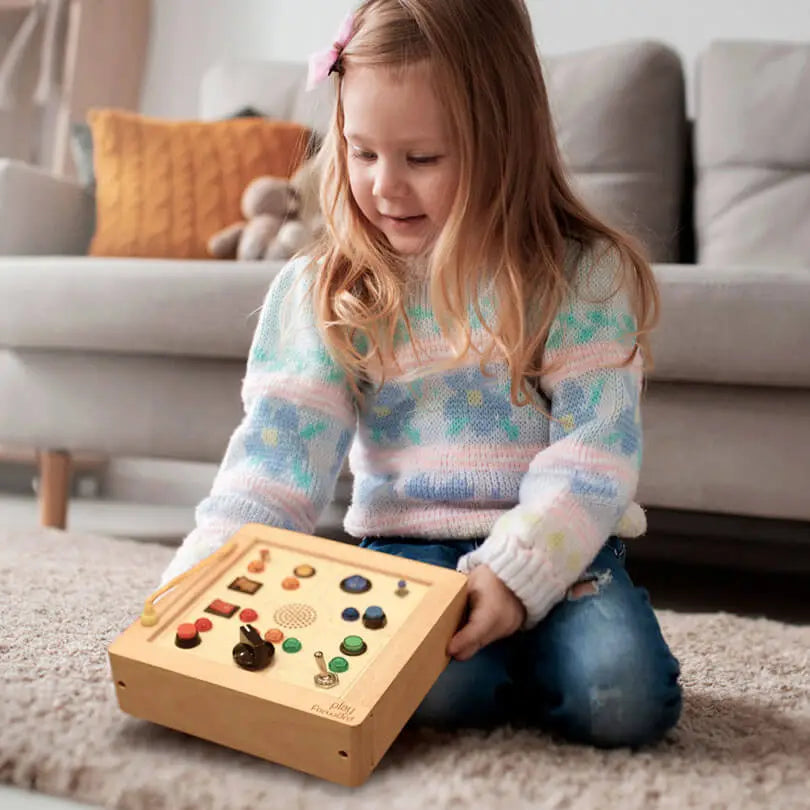 Child using Busy Buttons Light Board.
