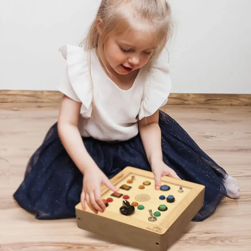 "Girl engaging with Busy Buttons Light Board.