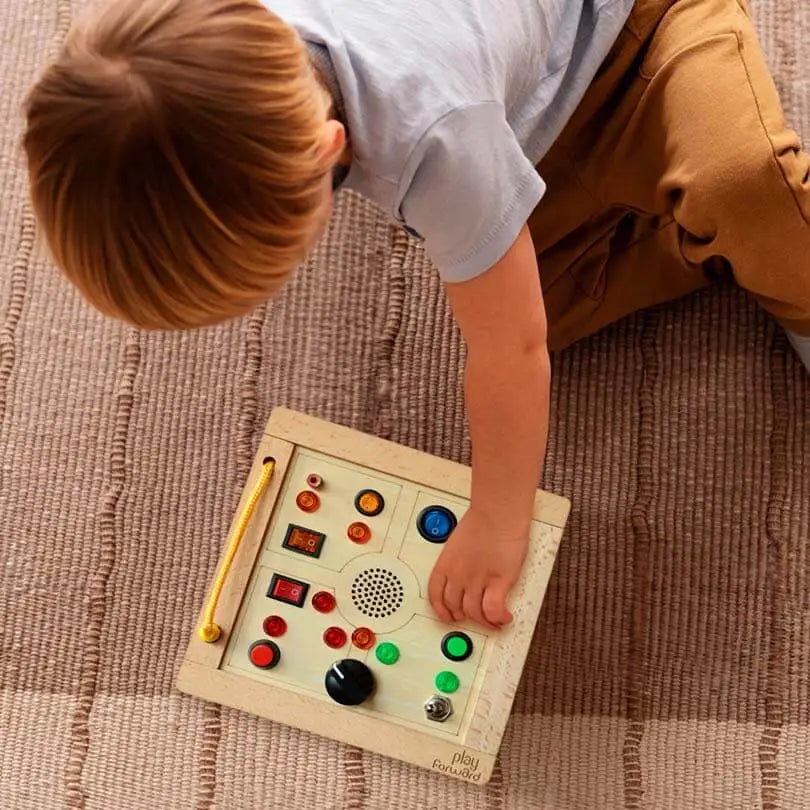 Toddler playing with Busy Buttons Light Board playfoward