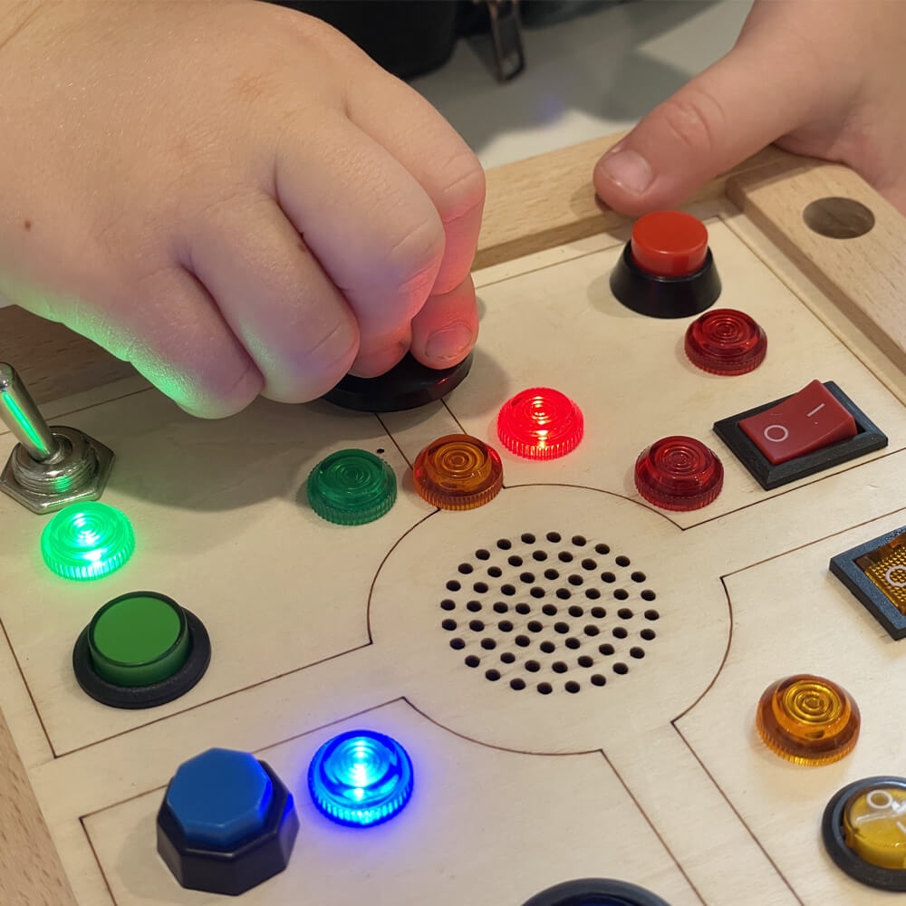Kid playing with Busy Buttons board
